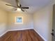 Bright bedroom with ceiling fan and wood-look flooring at 3749 Loury Dr, Wesley Chapel, FL 33543