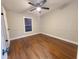 Bright bedroom with ceiling fan and dark brown laminate flooring at 3749 Loury Dr, Wesley Chapel, FL 33543