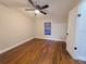 Well-lit bedroom with ceiling fan and dark brown laminate flooring at 3749 Loury Dr, Wesley Chapel, FL 33543