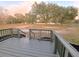 Gray deck with railing, offering outdoor space and relaxation at 3749 Loury Dr, Wesley Chapel, FL 33543