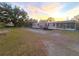 A beige manufactured home with a gray deck, landscaping, and screened porch at 3749 Loury Dr, Wesley Chapel, FL 33543