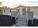 A beige manufactured home with a gray deck and landscaping at 3749 Loury Dr, Wesley Chapel, FL 33543