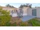 Mobile home exterior features gray deck and storage shed at 3749 Loury Dr, Wesley Chapel, FL 33543