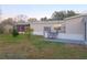 Mobile home with deck, screened porch, and large yard at 3749 Loury Dr, Wesley Chapel, FL 33543