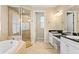 Spa-like bathroom with double vanity, soaking tub, and walk-in shower at 3814 W Sevilla St, Tampa, FL 33629