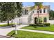 Two-story house with a white exterior, tile roof, and lush landscaping at 3814 W Sevilla St, Tampa, FL 33629