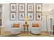 Two armchairs with a side table, framed photos and floor lamp at 3814 W Sevilla St, Tampa, FL 33629