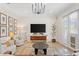 Living room features mid-century modern furniture and a large TV at 3814 W Sevilla St, Tampa, FL 33629