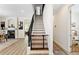 Elegant staircase with black metal railing and a safety gate at 3814 W Sevilla St, Tampa, FL 33629