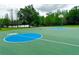 Outdoor basketball court with blue key areas near a lake at 4110 Huntingdale Ct, Wesley Chapel, FL 33543