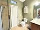 Bathroom with toilet, shower, and access to backyard at 4110 Huntingdale Ct, Wesley Chapel, FL 33543