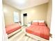 Spacious bedroom with two beds and ample closet space at 4110 Huntingdale Ct, Wesley Chapel, FL 33543