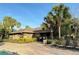 Community clubhouse exterior featuring lush tropical landscaping near the community pool at 4110 Huntingdale Ct, Wesley Chapel, FL 33543