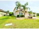 Side view of two-story house, showcasing landscaping and driveway at 4110 Huntingdale Ct, Wesley Chapel, FL 33543