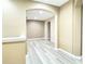 Bright hallway with wood-look flooring and archways at 4110 Huntingdale Ct, Wesley Chapel, FL 33543