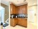 Additional kitchen counter space with wood cabinets and tile backsplash at 4110 Huntingdale Ct, Wesley Chapel, FL 33543