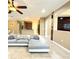 Spacious living room with sectional sofa and view into the kitchen at 4110 Huntingdale Ct, Wesley Chapel, FL 33543