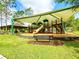 playground with shaded play structures and a bench at 4110 Huntingdale Ct, Wesley Chapel, FL 33543