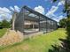 Large screened pool enclosure with backyard view at 4110 Huntingdale Ct, Wesley Chapel, FL 33543