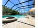 Inviting screened pool and spa with fire pit and patio at 4110 Huntingdale Ct, Wesley Chapel, FL 33543