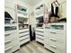 Bright walk-in closet with shelving and drawers at 4110 Huntingdale Ct, Wesley Chapel, FL 33543