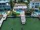 Aerial view of waterfront home with pool and dock at 476 Harbor S Dr, Indian Rocks Beach, FL 33785