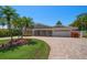 One-story home with circular driveway, landscaped lawn, and attached garage at 476 Harbor S Dr, Indian Rocks Beach, FL 33785