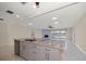 Kitchen island with granite countertops overlooks living room and water view at 476 Harbor S Dr, Indian Rocks Beach, FL 33785