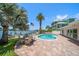 Inviting backyard oasis with kidney-shaped pool, patio furniture, and water views at 476 Harbor S Dr, Indian Rocks Beach, FL 33785