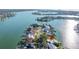 Aerial view of a waterfront property showcasing its location among lush landscaping and waterways at 521 Harbor N Dr, Indian Rocks Beach, FL 33785