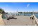 Waterfront property features a spacious wooden dock, complete with seating and stunning water views at 521 Harbor N Dr, Indian Rocks Beach, FL 33785