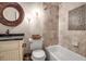 Bathroom with updated vanity, stone countertop, and tiled shower/tub at 5232 White Sand Ne Cir, St Petersburg, FL 33703