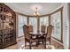 Cozy dining area with a round table and four chairs, surrounded by windows at 5232 White Sand Ne Cir, St Petersburg, FL 33703