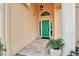 Inviting entryway with a green door, tile flooring, and a small planter at 5232 White Sand Ne Cir, St Petersburg, FL 33703