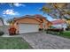 Tan house with a white garage door and a nicely landscaped front yard at 5232 White Sand Ne Cir, St Petersburg, FL 33703