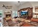 Elegant living room with a stone fireplace and comfortable leather sofas at 5232 White Sand Ne Cir, St Petersburg, FL 33703