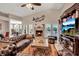 Spacious living room with leather sofas, a fireplace, and built-in entertainment center at 5232 White Sand Ne Cir, St Petersburg, FL 33703