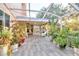 Lush, screened porch with string lights and potted plants at 5232 White Sand Ne Cir, St Petersburg, FL 33703