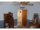 Bedroom featuring blue walls, a ceiling fan with light fixture, and wood furnishings at 5353 Shaw St, New Port Richey, FL 34652