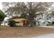 This single-story home features a welcoming front yard, carport, and covered entryway at 5353 Shaw St, New Port Richey, FL 34652