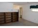 View of living room with tiled floor, built-in shelving, and access to another room at 5353 Shaw St, New Port Richey, FL 34652