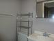 This is a bathroom with a commode, vanity, shelving and mirror at 6567 S West Shore Cir, Tampa, FL 33616