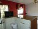 Kitchen counter area featuring a microwave and corner table, with bright lighting and adjacent room at 6567 S West Shore Cir, Tampa, FL 33616