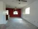 Bright, open living area showing a bar overlooking a red accent wall dining room space with an open floor plan at 6567 S West Shore Cir, Tampa, FL 33616