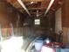 Interior view of shed with wooden walls, ceiling beams, lighting, and miscellaneous clutter at 6567 S West Shore Cir, Tampa, FL 33616