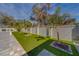 Landscaped backyard with artificial turf and paver patio at 659 Keene Rd, Largo, FL 33771