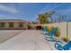 Relaxing backyard patio with blue rocking chairs and grill at 659 Keene Rd, Largo, FL 33771