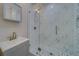 Updated bathroom with a stylish glass shower and marble tile at 659 Keene Rd, Largo, FL 33771