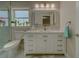 Clean bathroom, featuring white vanity, marble floor, and a shower at 659 Keene Rd, Largo, FL 33771