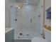 Modern bathroom with a glass shower, marble tile, and updated fixtures at 659 Keene Rd, Largo, FL 33771